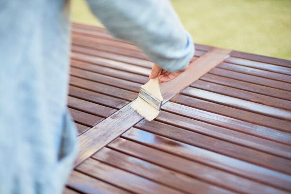 Handyman Oiling A Timber Deck
